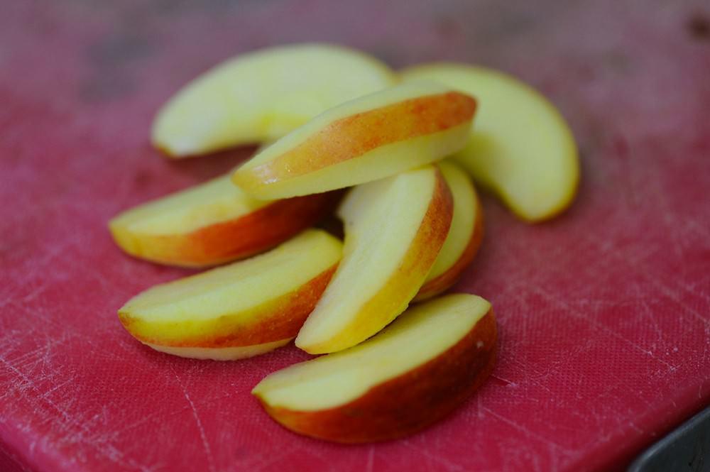 יש לחתוך תפוחים לשארלוט לפרוסות שוות. אין צורך לקלף את הפרי